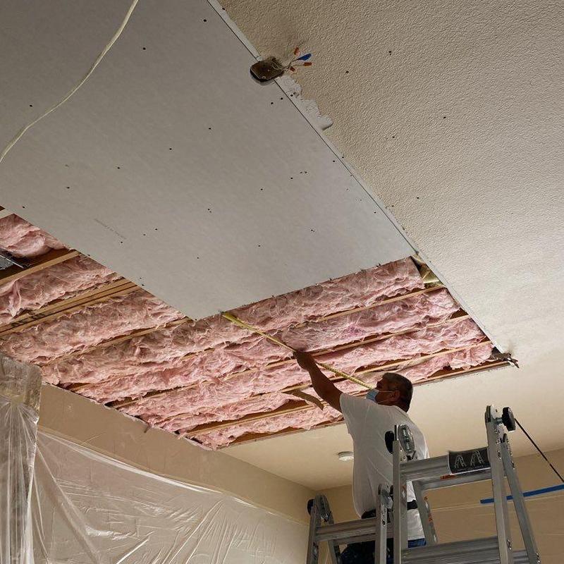 worker repairing drywall
