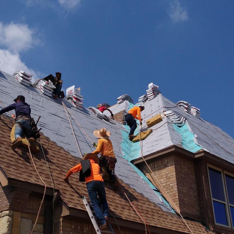workers providing roof installation